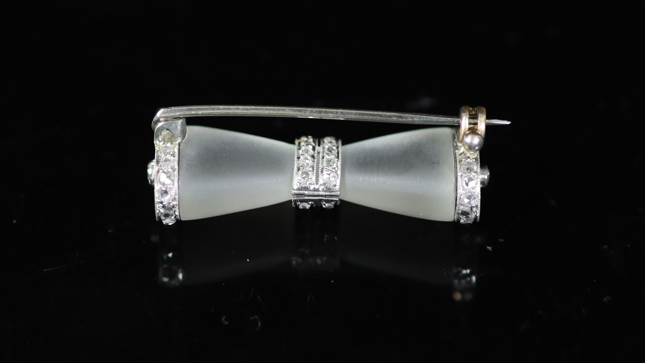 A 1930's/1940's engraved white gold, frosted glass and rose cut diamond set 'bow tie' brooch